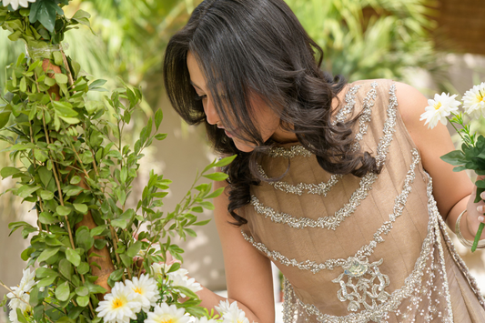 Model wearing embroidered taupe net formal set with silver embellishments by Alishba Kashif Studio