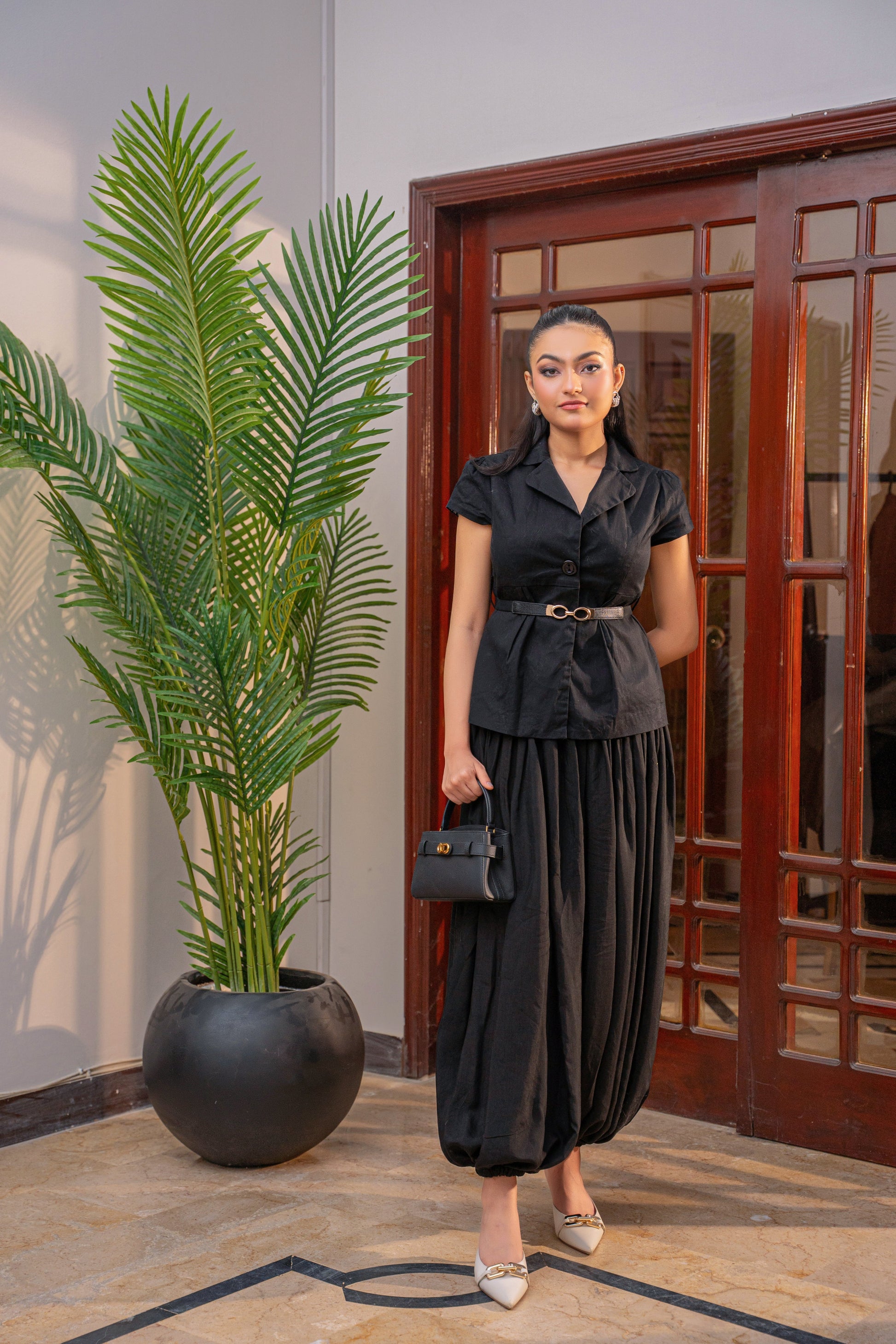 Luna Noir black coord set by Alisho - model holding bag, full length