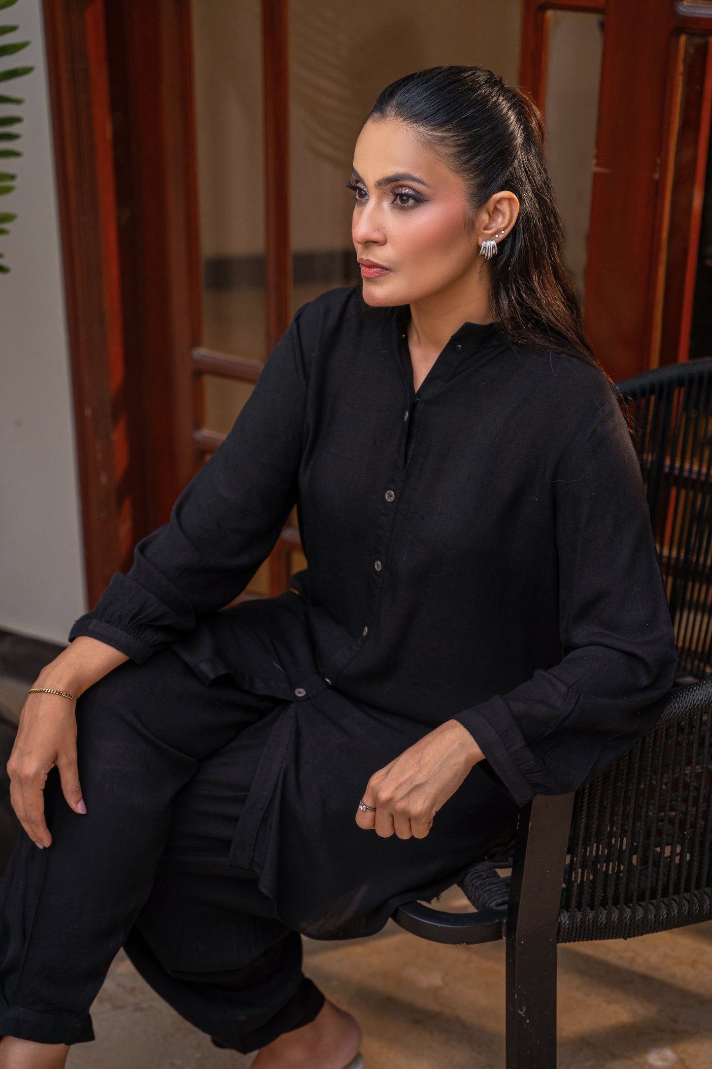 Void black viscose button-down shirt by Alisho - model seated, editorial close up
