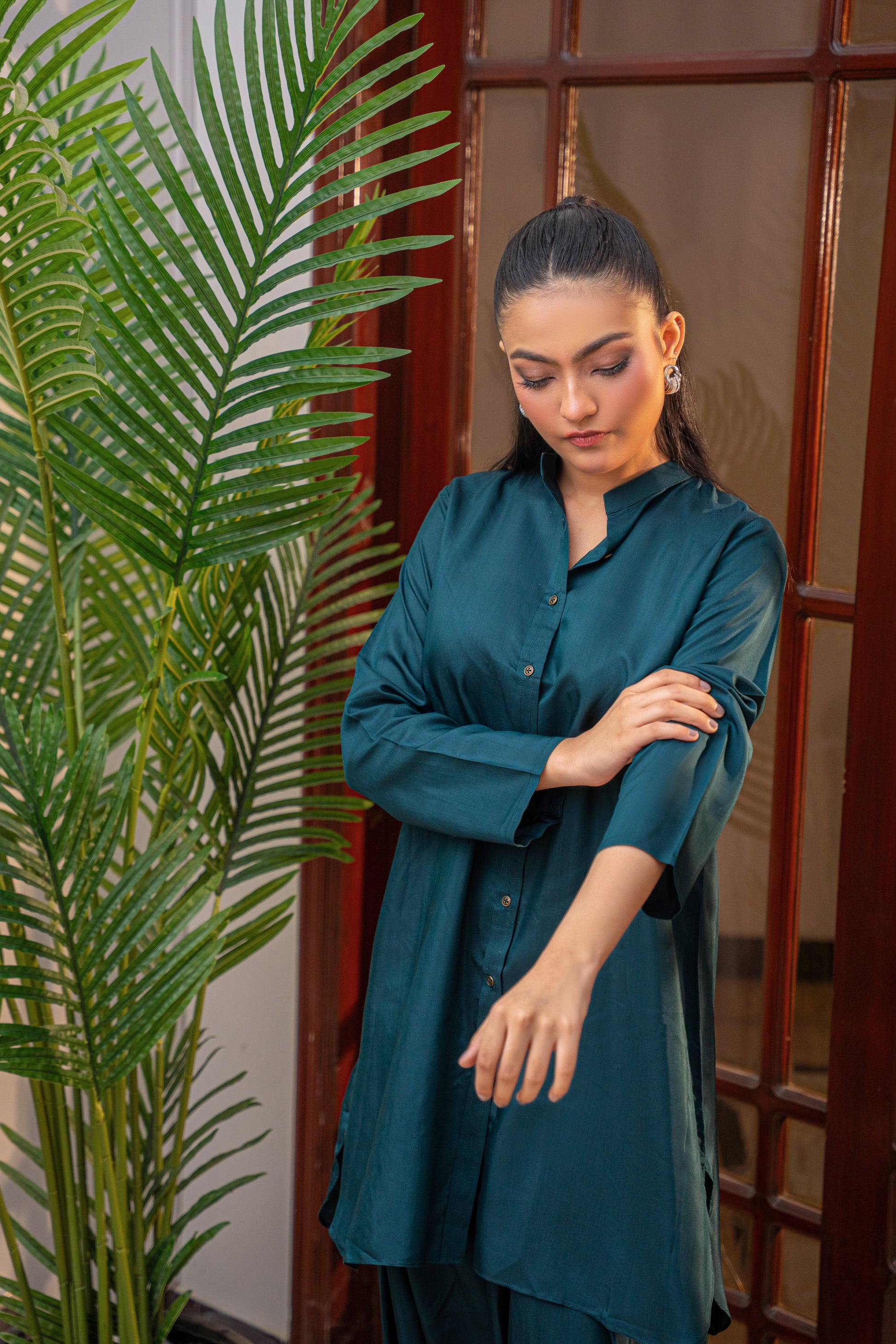Deep Serenity teal viscose shirt by Alisho - model looking down, rekaxed pose