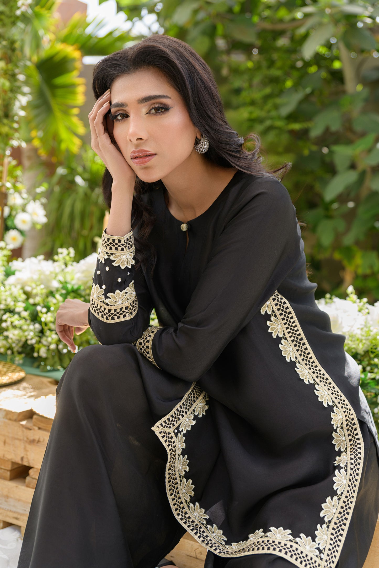 Noir Elegance - black sheesha silk suit with ivory lace border sitting pose by Alishba Kashif