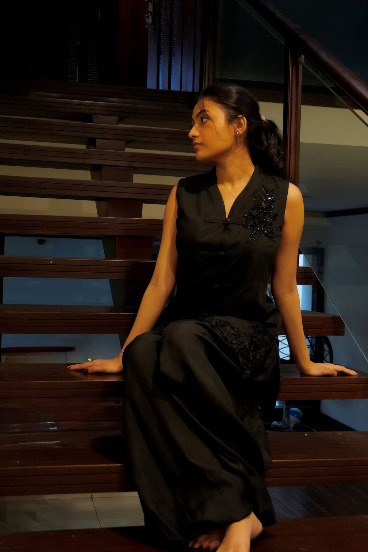 Alisho After Dark black sleeveless top and balloon pants worn indoors