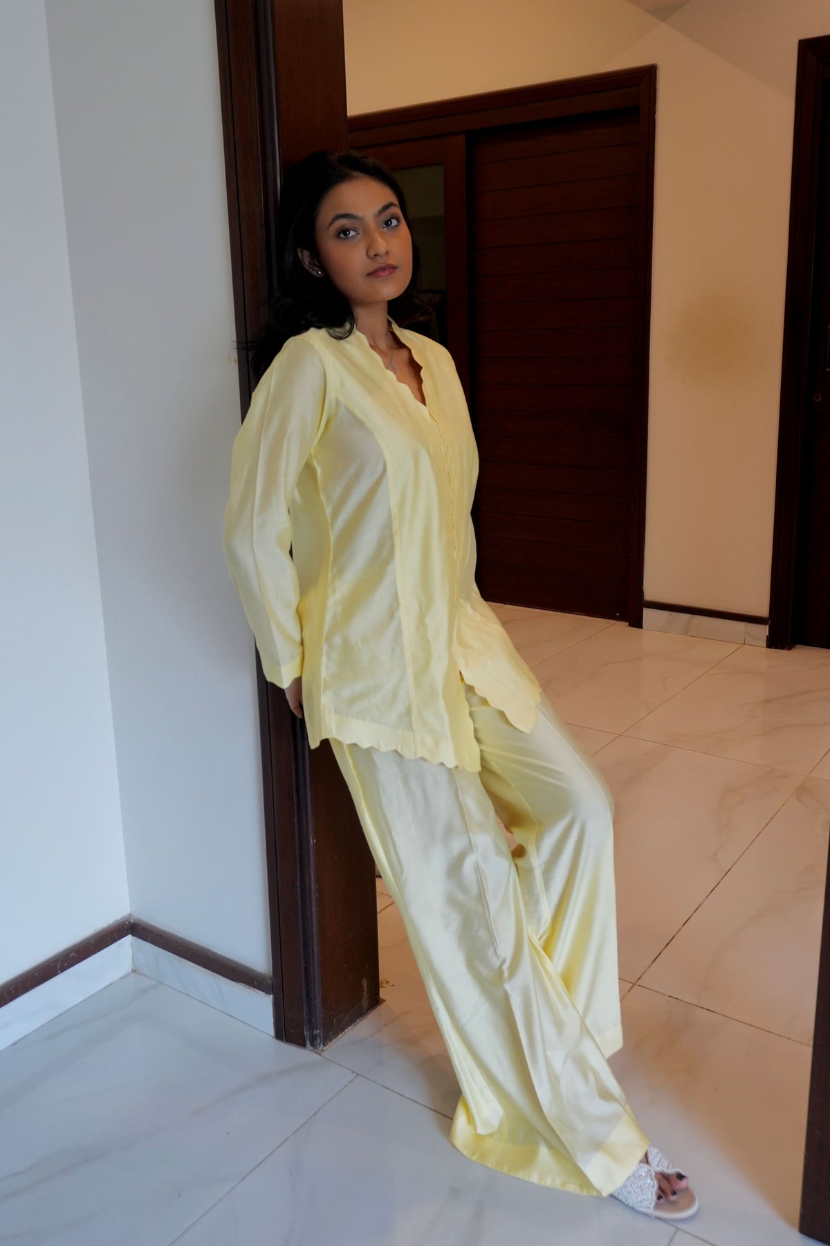 Alisho Buttercream shirt and bootcut pants set worn by a model side