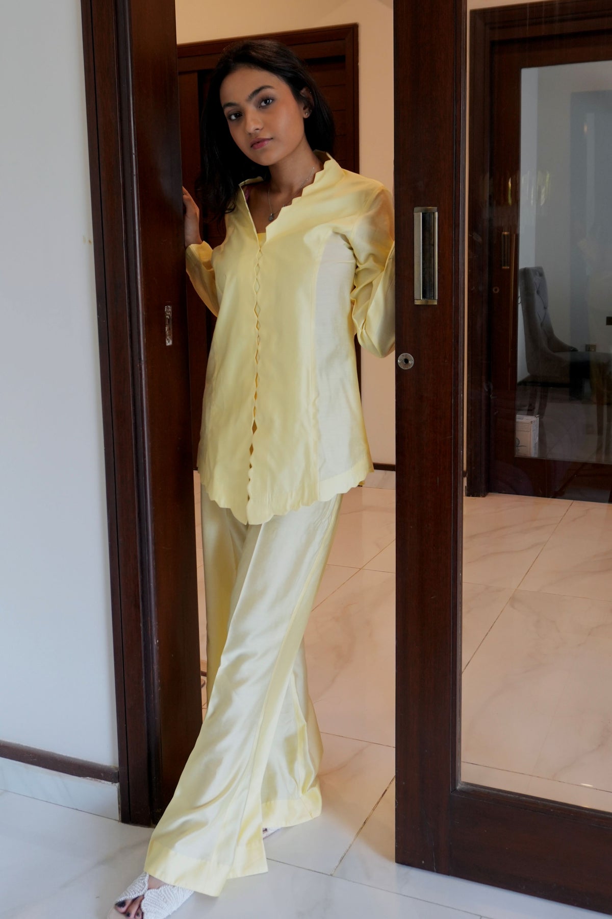 Alisho Buttercream shirt and bootcut pants worn by a model 