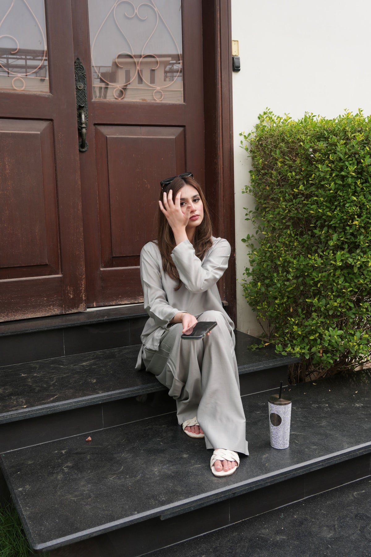 Alisho Luna grey kurta and farshi shalwar set worn by a model seated outdoors
