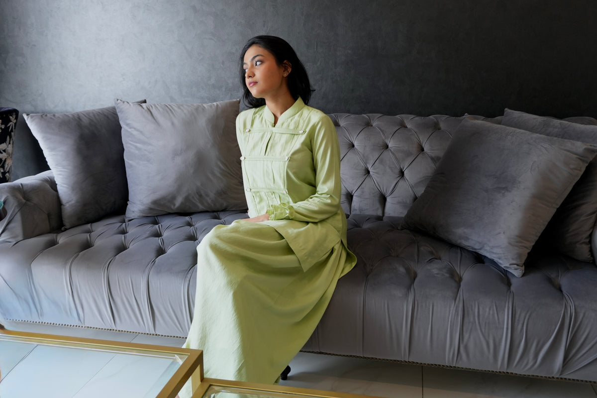 Alisho Matcha Mood matcha green Mandarin-collar top and balloon pants worn by a model on a sofa