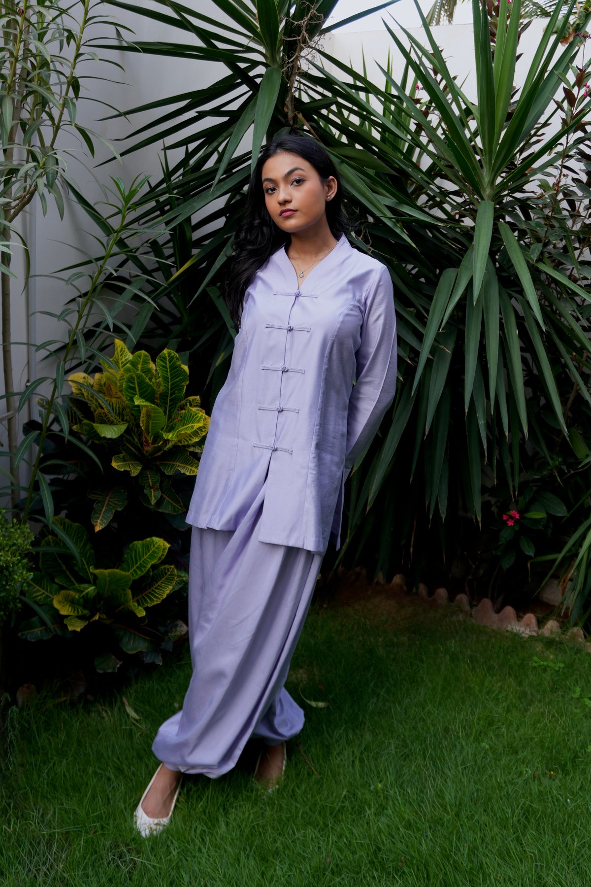 Lilac theory two-piece set featuring mandarin top and matching voluminous balloon pants. standing in lawn. alisho by alishba kashif studio