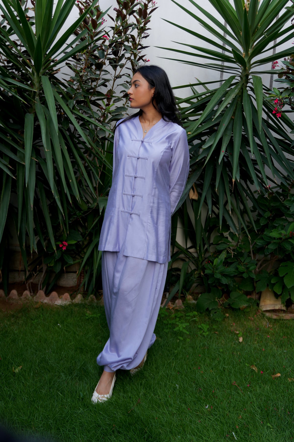 Lilac theory two-piece set featuring mandarin top and matching voluminous balloon pants. standing on a green lawn in front of a backdrop of large green plants. - alisho by Alishba Kashif 